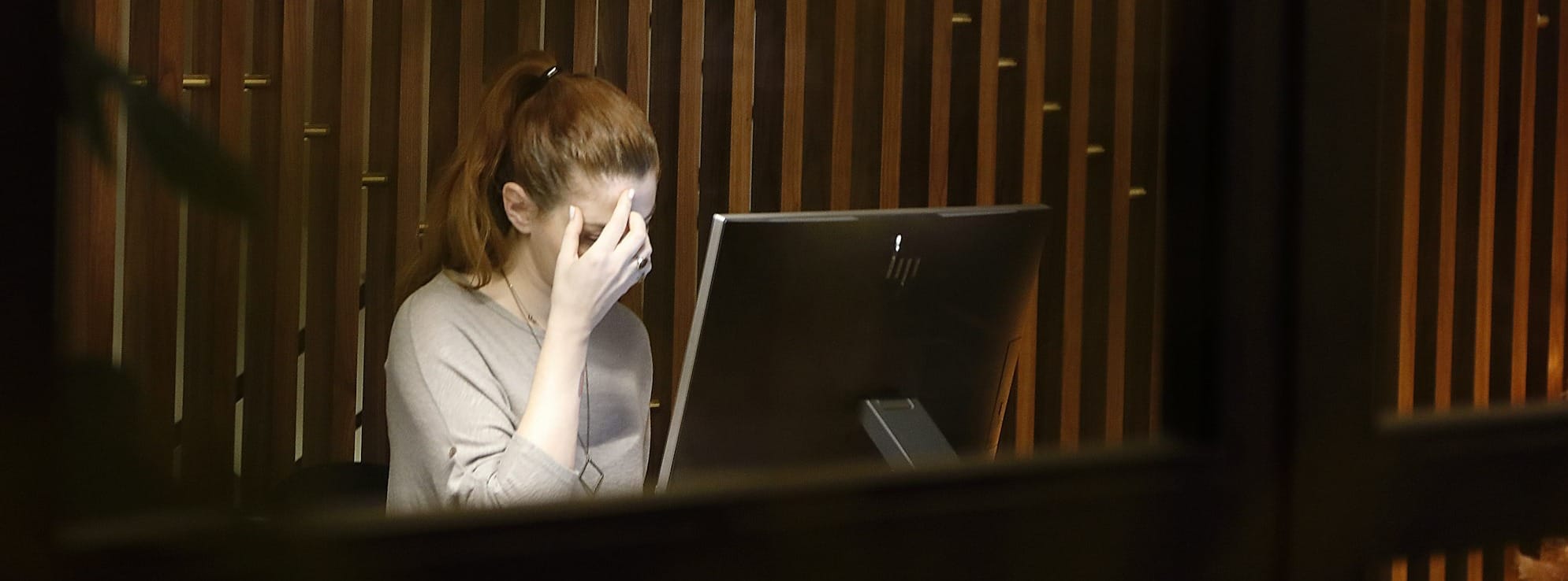 a woman sitting in front of a laptop computer